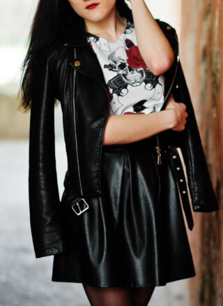 Damen Lederrock, Frau in schwarzem Lederrock mit Lederjacke in Schwarz